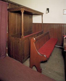 View of interior. Detail of pews, original pannelled oak pew to left