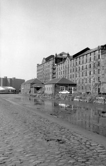 View from SW showing part of W front of City of Glasgow Grain Mills with Sugar Refinery in background