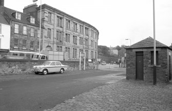 View from S showing ESE front of S block with N block of works in background and numbers 475-479 High Street on left and small harbour building on right