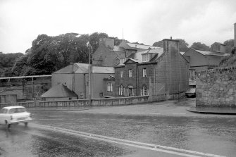 View from E showing ENE and SSE fronts of office with mill buildings in background