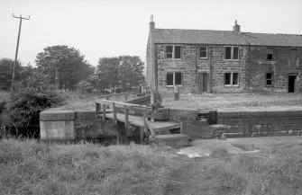 View from SSE showing top of W lockgates with part of lockeeper's house and stables in background