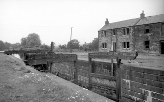 View from E showing remains of E lockgates with part of lockeeper's houses and stables on right