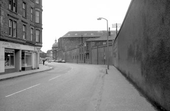General view looking WNW showing S front (Baltic Street front) of gasworks with part of tenement and shop on left