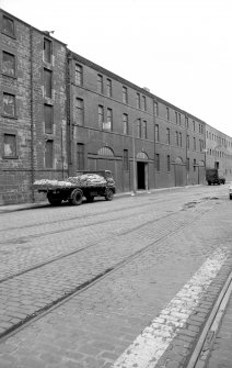 View from E showing NNE front of number 8a with number 8b in background and part of warehouse in foreground