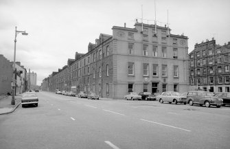 General view from SE showing SSW and ESE fronts of warehouses with part of numbers 2-11 Dock Place on right