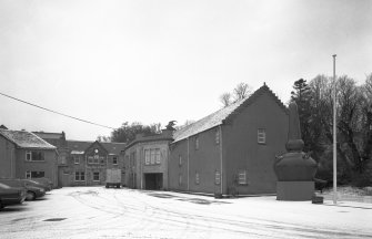 View from E along N side of distillery, showing yard, N side of Malt Storage Bins (part of Still House block), Reception Centre and (right) Office building containing Manager's Office and Committee Rooms.
Digital image of C 24217.