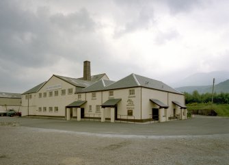 General view from SW of main block, including the two Tun Rooms, Mash House, Malt House and boiler House chimney.
Digital image of B 74726 CN.