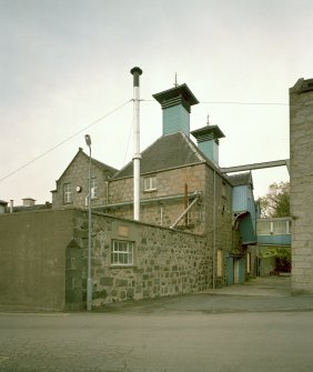View from S of two Kilns (L), W end of Maltings, and overhead walkway between the two buildings. Note also the wind vanes on the two kiln ventilators.
Digital image of C 64408 CN.