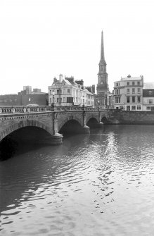 View looking S showing part of WNW front of bridge with number 2, numbers 3-17 New Bridge Street and Town Hall in background