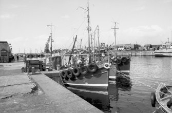 View from S showing fishing boats at S quay