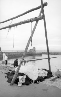 View from S showing part of wooden frame for net drying with light-tower in background