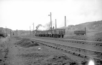 View from SE showing NCB locomotive and wagons near washery with brickworks in background