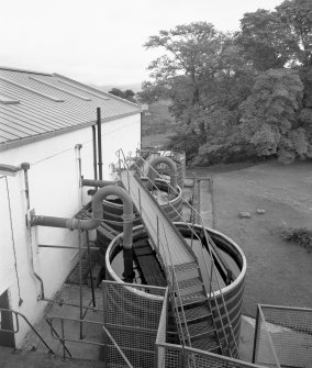 Skye, Carbost, Talisker Distillery.
Elevated view along South-West side of Still House, looking onto five wooden worm tubs.
Digital image of C 24404