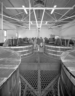 Skye, Carbost, Talisker Distillery, interior.
Tun Room: view from South-West showing the six wooden washbacks; also showing a party of visitors on guided tour of distillery.
Digital image of C 24385