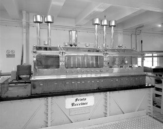Skye, Carbost, Talisker Distillery, interior.
Still House: detail of spirit safe and cast-iron feints receiver (below). These, and most of the plant, were installed by Abercrombie of Alloa in 1962 in the aftermath of the 1959 fire.
Digital image of C 24394