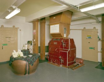 Skye, Carbost, Talisker Distillery, interior.
Mill House: View of Porteus (of Leeds) Malt Mill, and to left, display showing samples of malt and grist, and bottle of Talisker single-malt whisky (one of the six "Classic Malts" marketed by United Distillers
Digital image of C 24381 CN