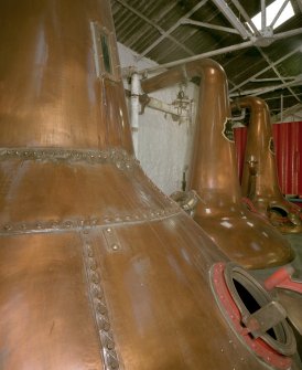 Still House:  view from SE of riveted wash still (foreground), with two spirit stills (welded copper) in background, and wash charger in far distance (low wines charger out of picture to right)
Digital image of C 64621 CN