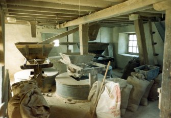 New Barony Corn Mill: View of millstones, hoppers etc.
PRINT FILED IN MS/500/35/17.
Digital image of B 26192 CN.