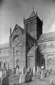 Kirkwall, St Magnus Cathedral.
View from S showing part of SSW front of cathedral with part of graveyard in foreground.
