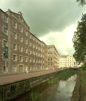 New Lanark: view from E of lade as it passes in front of Mill No. 3, with Mills No. 2 and 1 in the distance