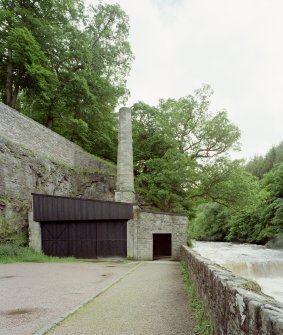 View from N of chimney stalk and retort house associated with former gas works.  The retort house had been converted to a viewing point for the waterfalls, which were illuminated at night with different coloured light