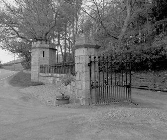 Gate pier, wrought iron gate, wall surmounted by railings and pavilion, detail
Digital image of D/31622