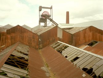 Newtongrange, Lady Victoria Colliery, Pithead Building (tub Circuit, Tippler Section, Picking Tables)
View from S of the colliery headgear, with the corrugated sheet-metal roofs and upper walls of the Picking Tables and Tub Circuit buildings in the foreground