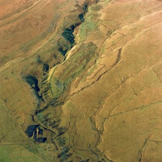 Oblique aerial view of Thief Sike centred on the remains of a township, field-system, rig, quarry and pen with the remains of a possible hut-circle, cultivation terraces, small cairns, shieling-huts and a possible sheepfold adjacent, taken from the SE. Digital image of D/24590/CN.