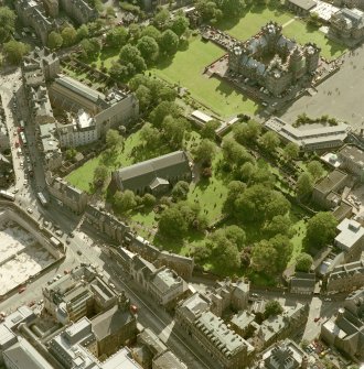 Scanned image of oblique aerial view, taken from the NNE, centred on Candlemaker Row, Greyfriars Church and burial-ground.