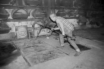 Interior 
View of retort house showing man working