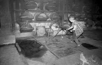 Interior 
View of retort house showing man working