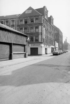 View from W showing SSW and part of WNW fronts with covered market in foreground