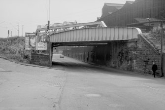 View from N showing bridge over Duke Street with part of Parkhead Forge in background