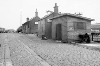 View from NW showing buildings and cobbled yard