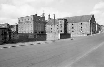 View from SE showing SSW and ESE fronts of E bay wing with castellated hoist block and central silo block