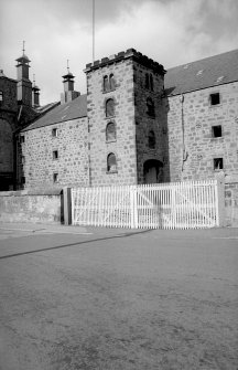 View from SE showing SSW and ESE fronts of castellated hoist block on E bay wing