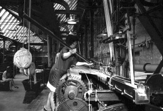 Interior
View showing woman using fur stick on 27' setting loom