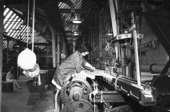 Interior
View showing woman combing up on 27' setting loom