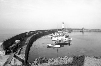 View from S showing breakwater and moored ships