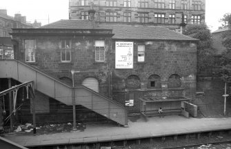 View from E showing E front of booking office and station house with platform below
