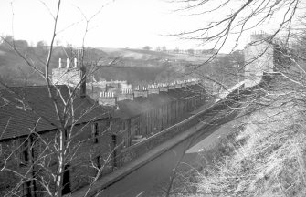 View from E showing NE front of no 128 New Lanark Road with Long Row in middle background and no 158 New Lanark Road in right background
