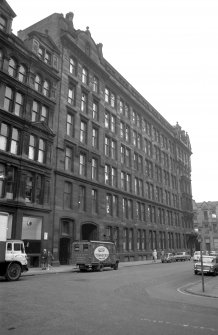 View from N showing WNW front of factory with part of warehouse in foreground and 117 Ingram Street in background