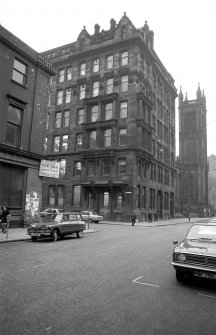 View from WSW showing SSW and part of WNW fronts of factory with part of church in backround and no 118 Ingram Steet in foreground