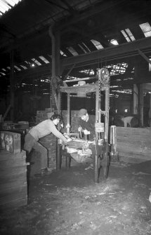 Interior
View showing men working on hand-moulding machine
