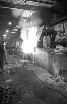 Interior
View showing men working induction furnace