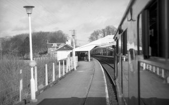 View from SSW showing locomotive approaching station buildings and awning