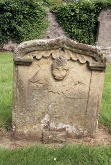 Smailholm Church, Graveyard. View of headstone showing cherub, trade emblems and symbols of mortality.