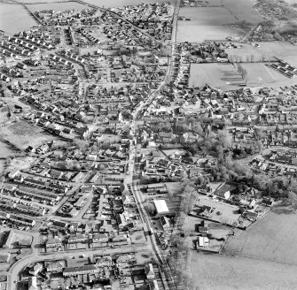 Oblique aerial view of the town centred on the church, taken from the NW.