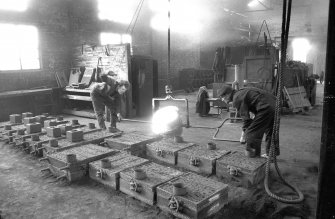 Interior
View showing men pouring iron into mould
