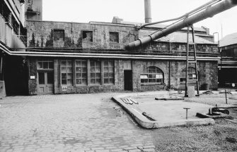 View from NW showing NW fronts of exhauster house (L) and liquor pump house (R)